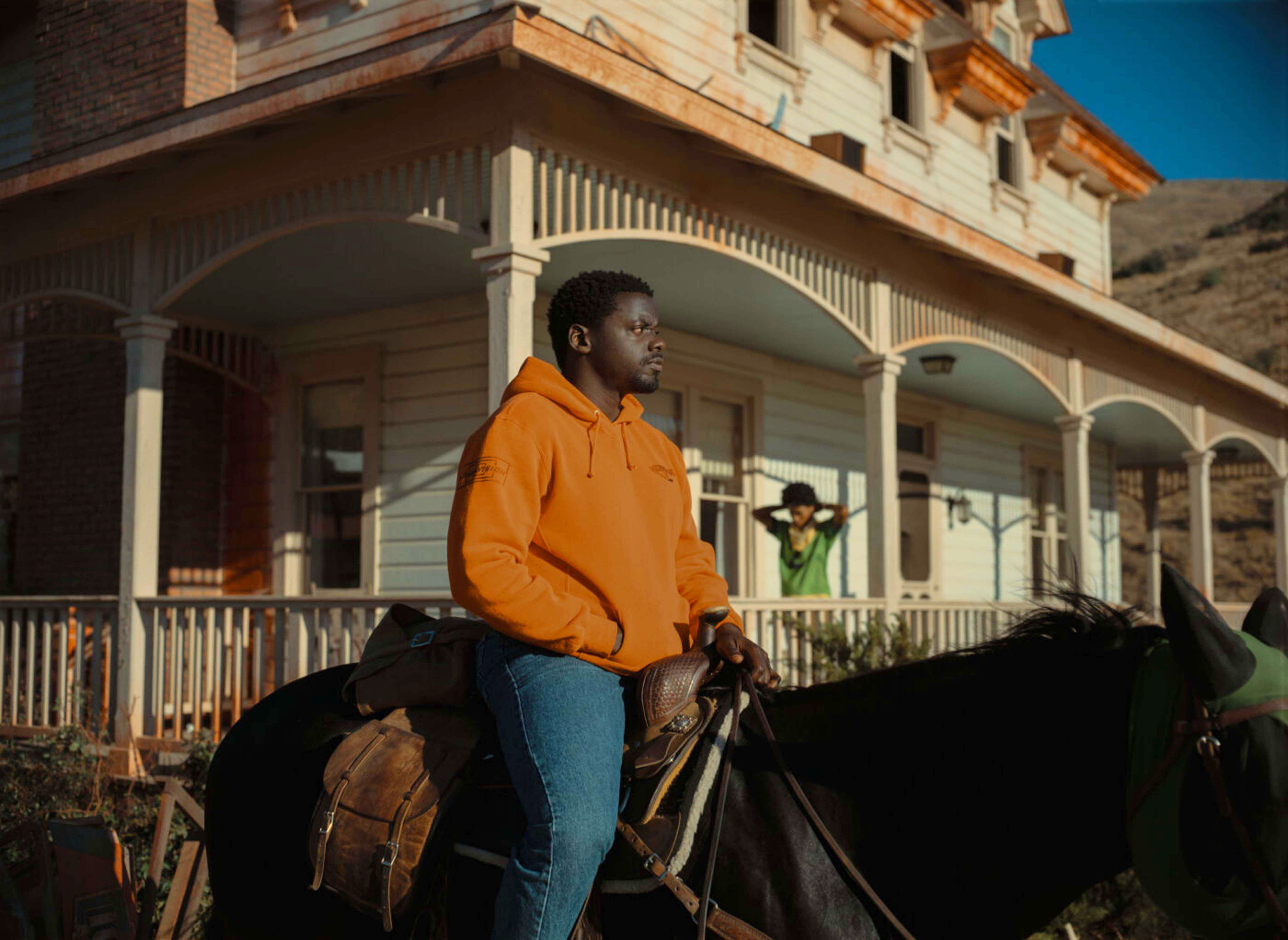 Daniel Kaluuya rides a horse against an ominous backdrop.
