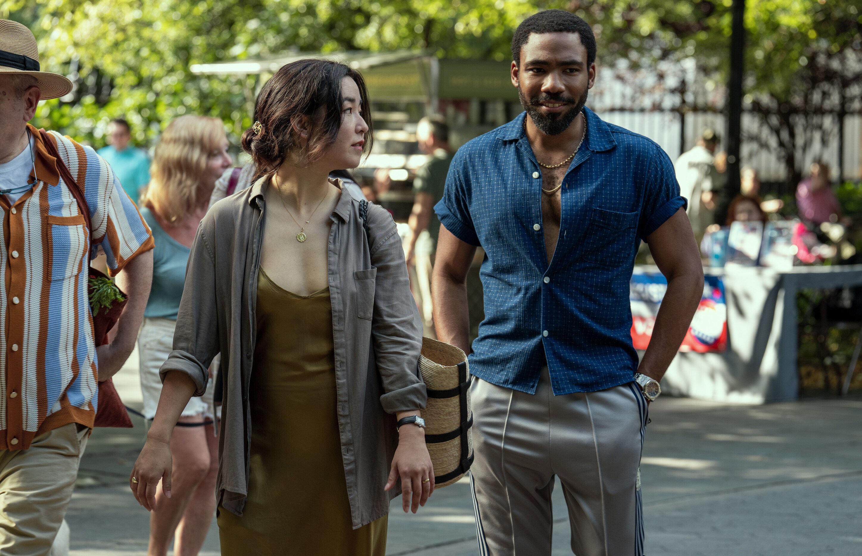 a man and a woman are walking down a street
