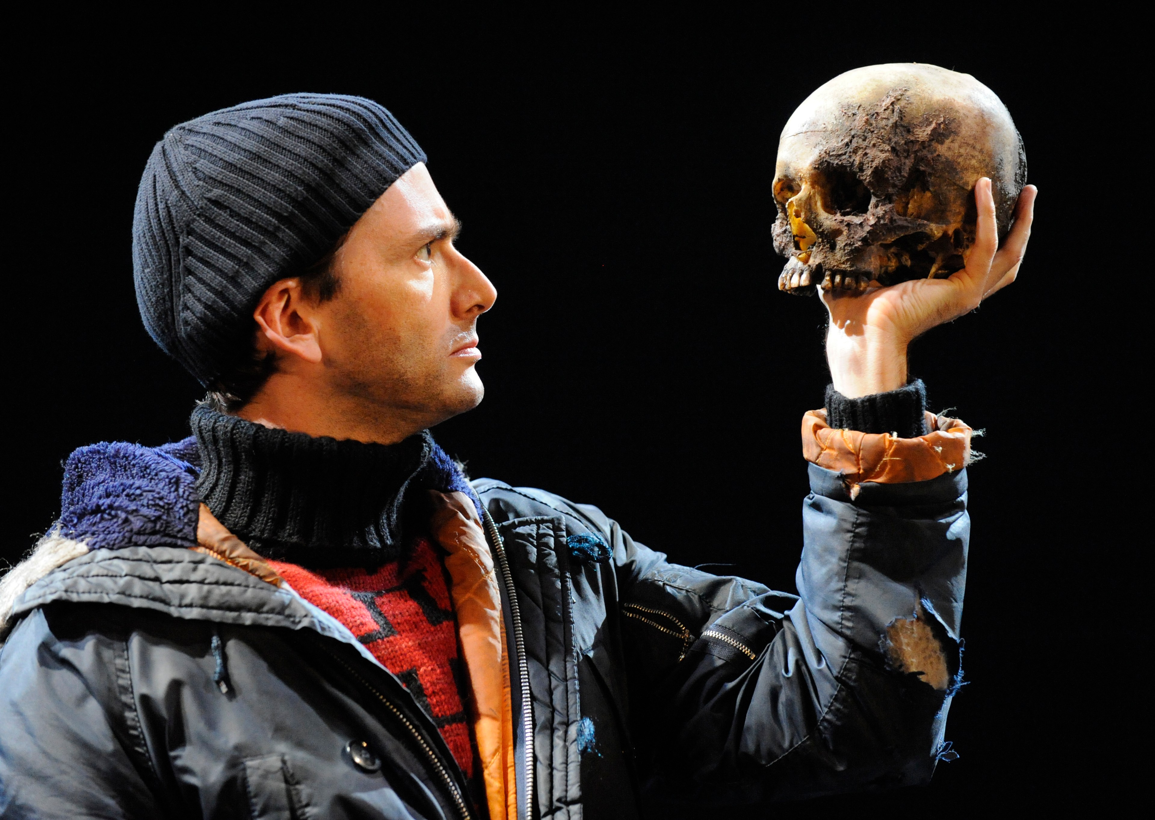 David Tennant as Hamlet holding a skull.