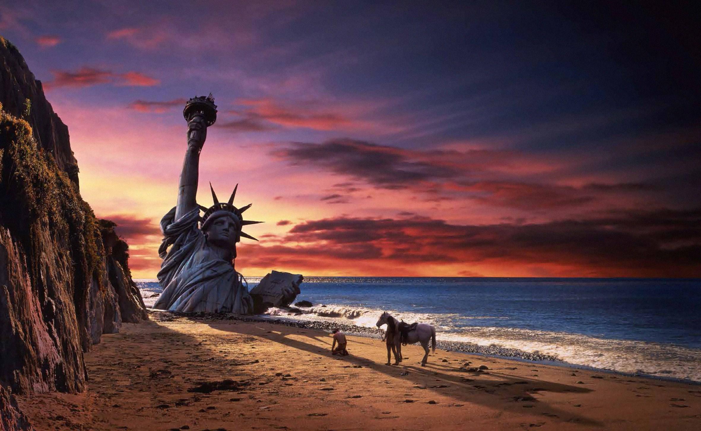 Planet of the Apes statue submerged on a beach at sunset.
